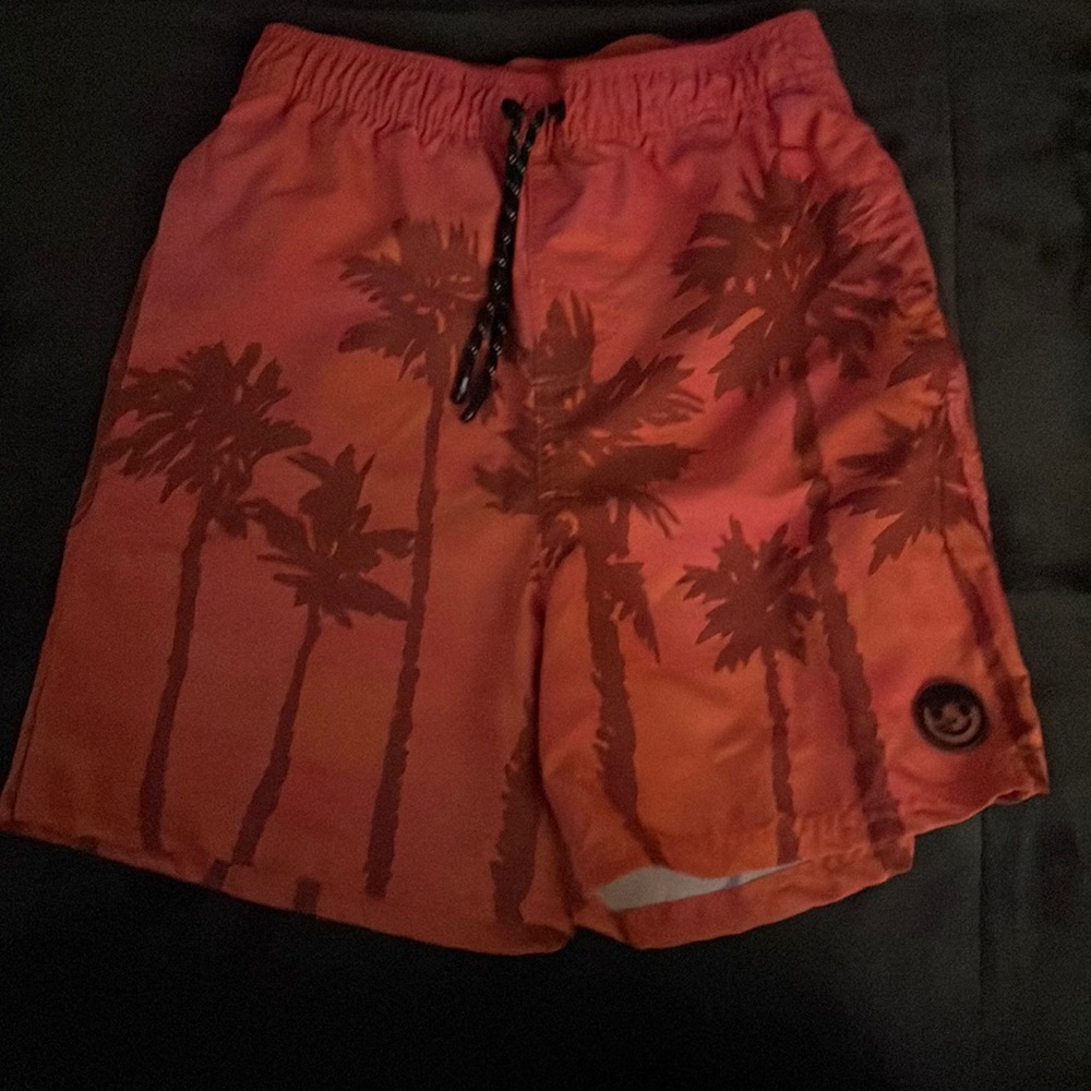 Orange medium palm tree printed swim trunks.